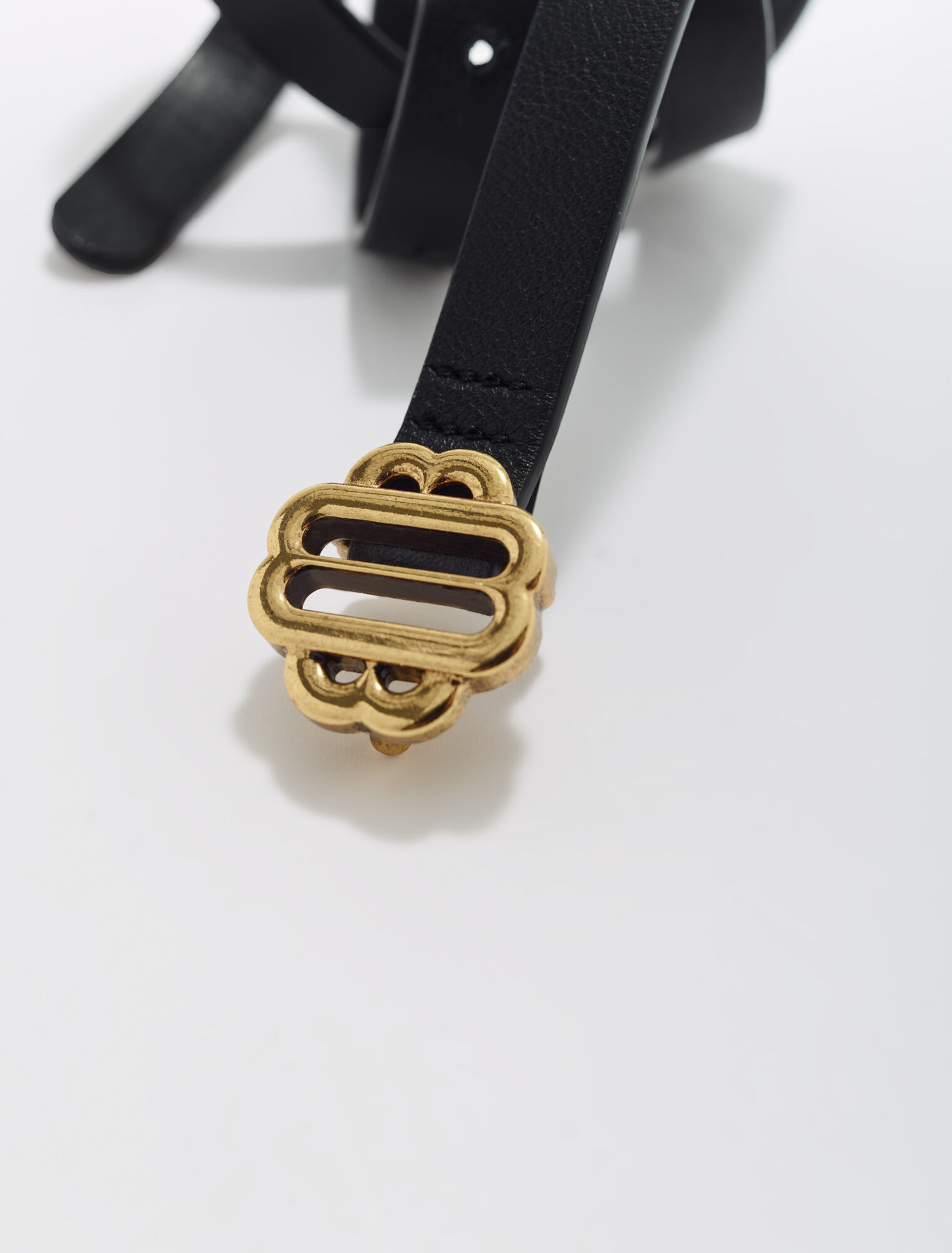 Narrow black leather belt gold buckle